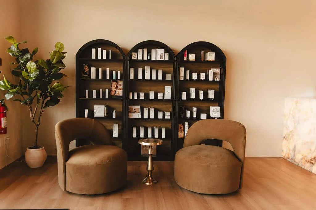 Ageless Rituals Med Spa waiting area with plush chairs and product shelves.